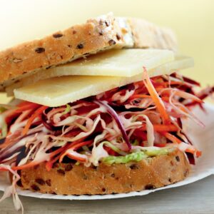 Avocado, shredded slaw and cheese sandwich