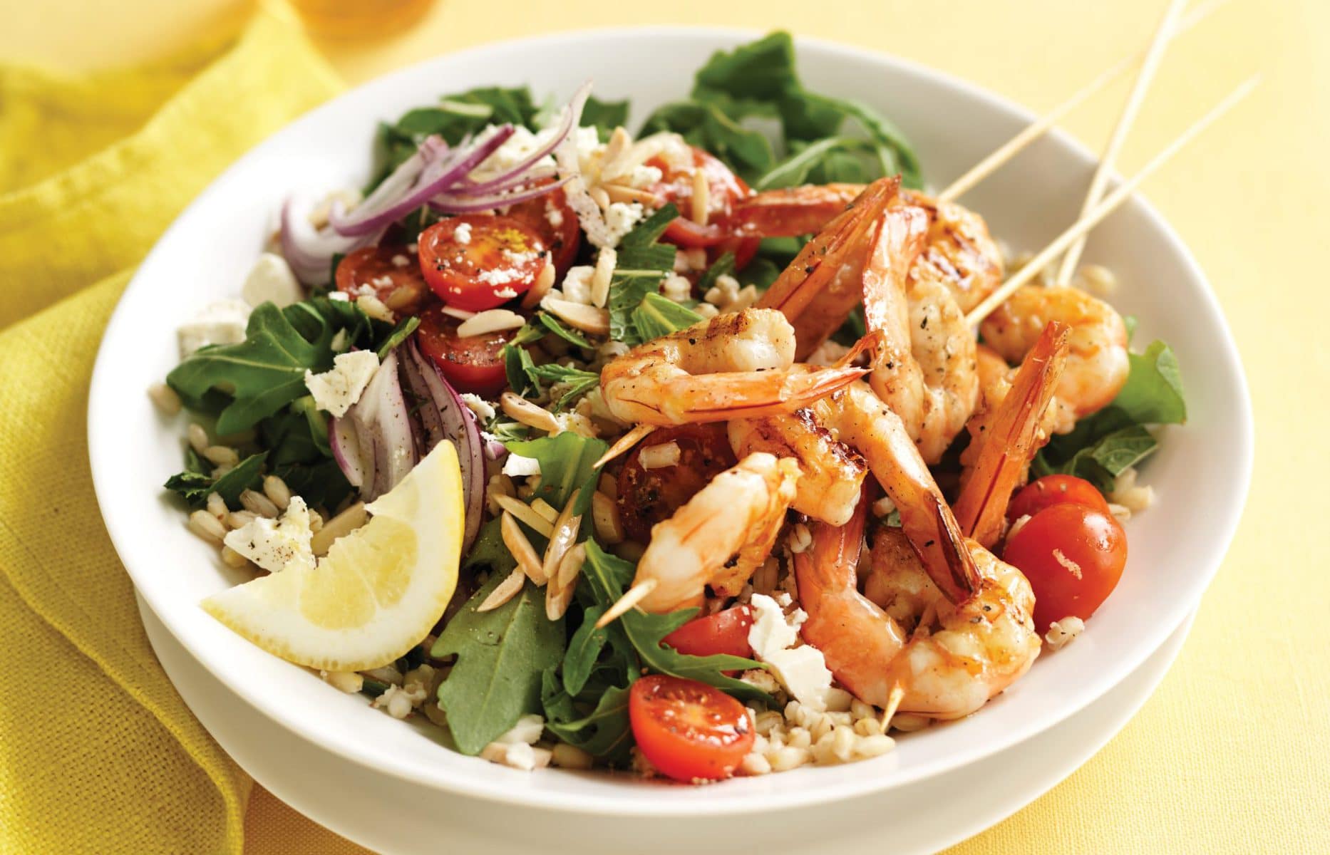 Grilled prawn skewers with barley and almond salad