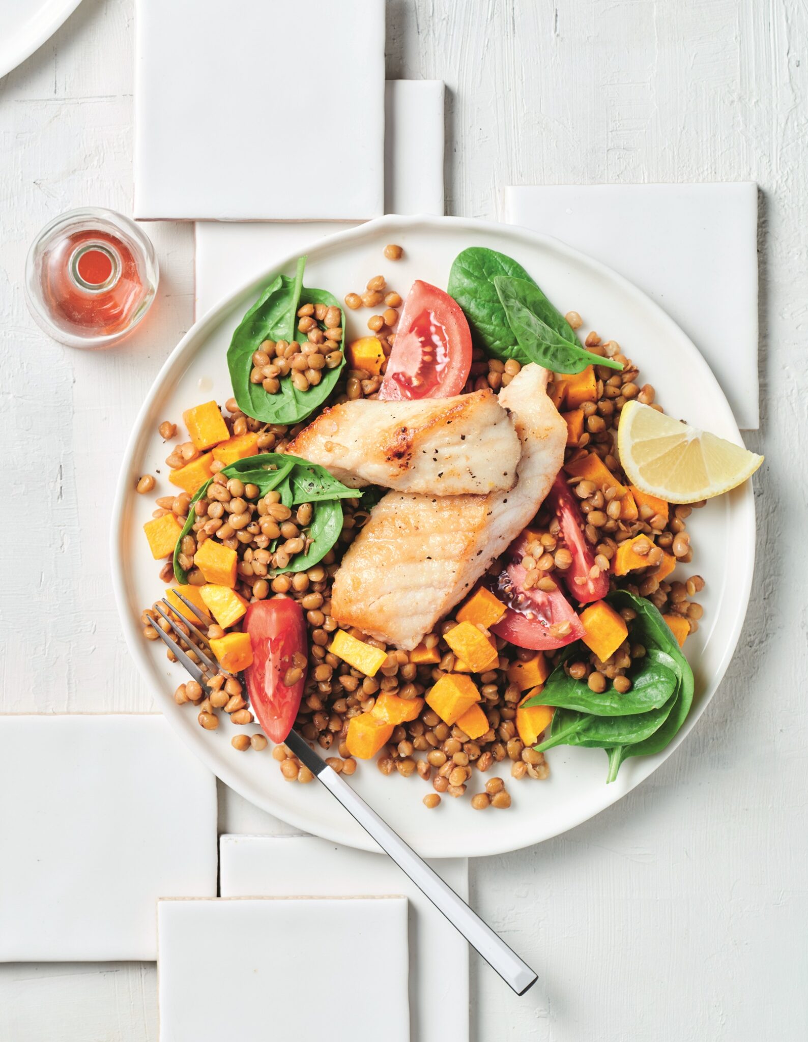 Pan-fried fish with lentil and spinach salad