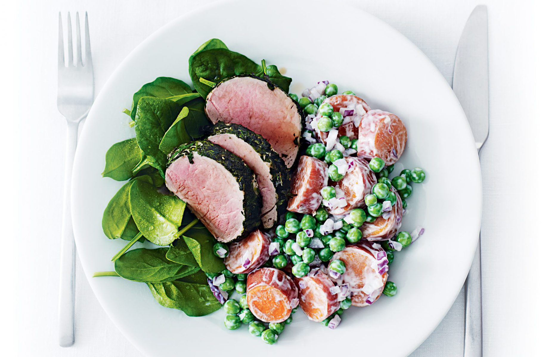 Herb-crusted pork with kumara and pea salad