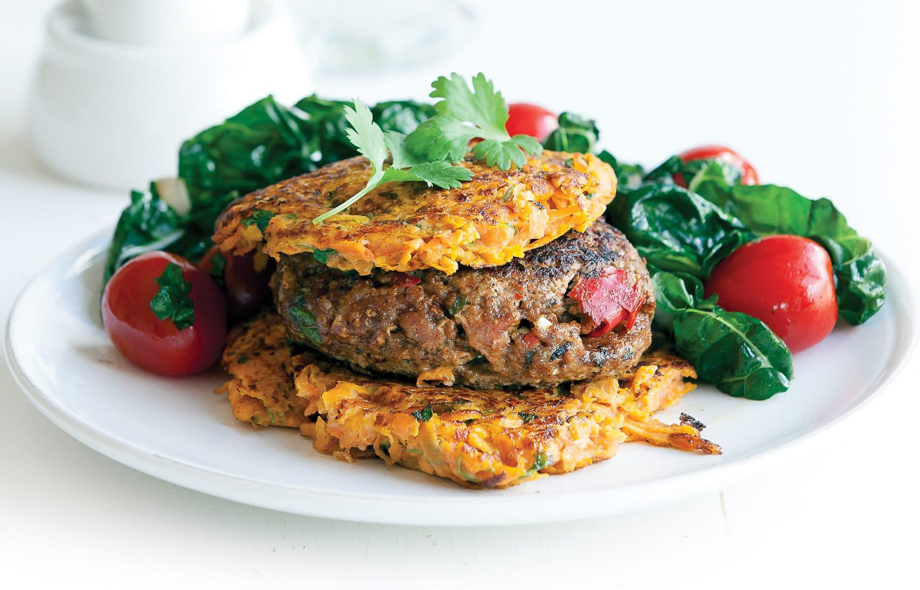 Lamb burgers with kumara fritters and silver beet