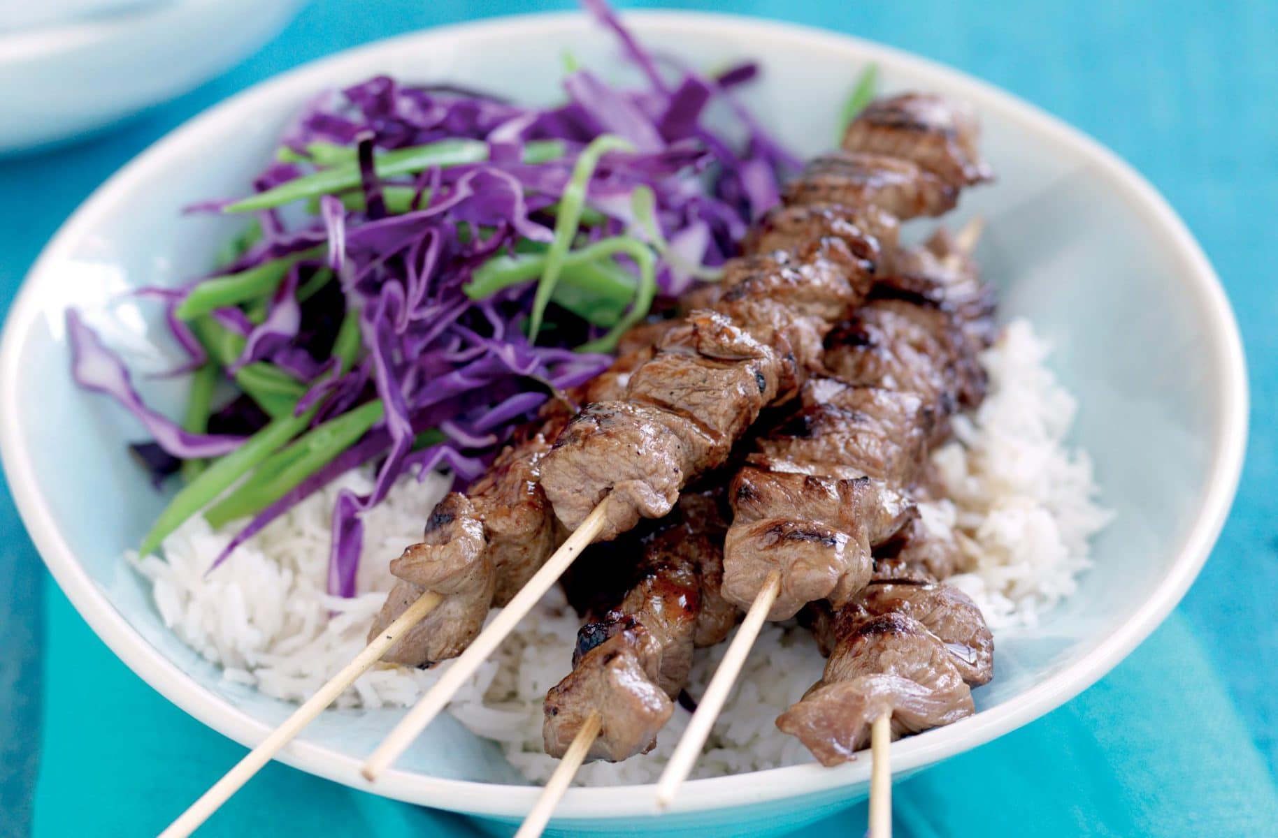 Teriyaki beef skewers with cabbage salad