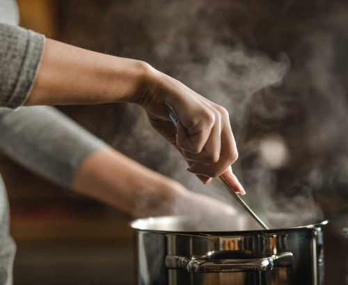 Person stirring a pot
