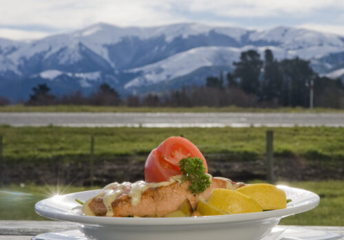 food on a plate in front of mountains new zealand