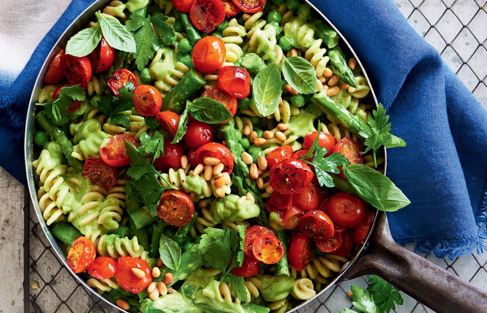 Avocado pesto pasta with peas, asparagus and roasted tomatoes