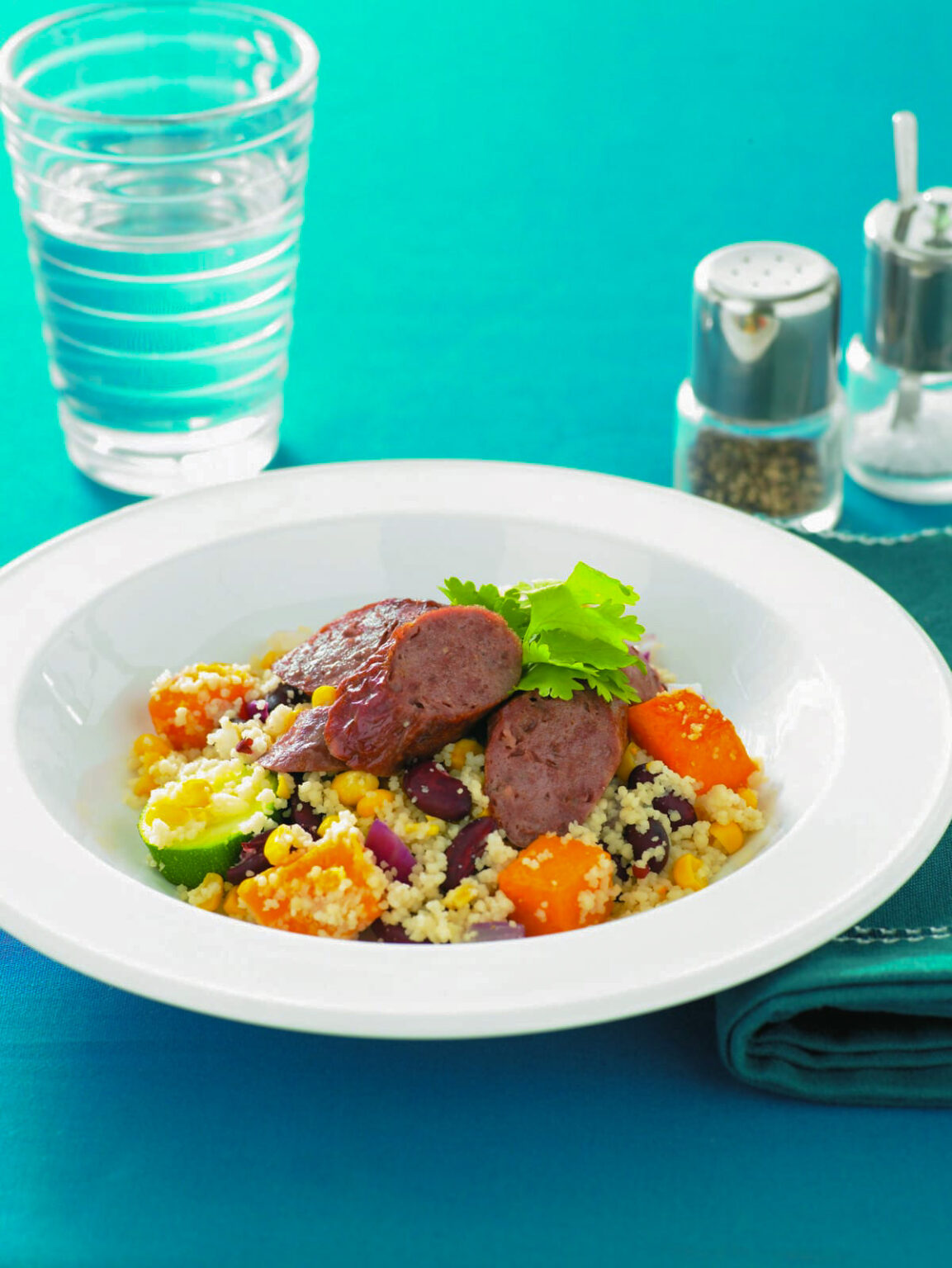 Baked vegetable couscous with sausages