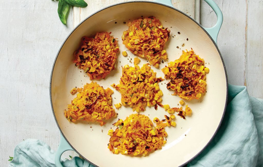 Corn and pumpkin fritters with herby hummus