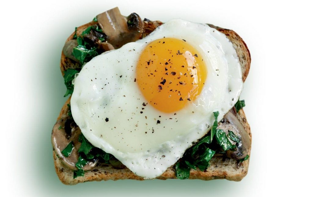 Egg, mushroom and wilted kale toast topper