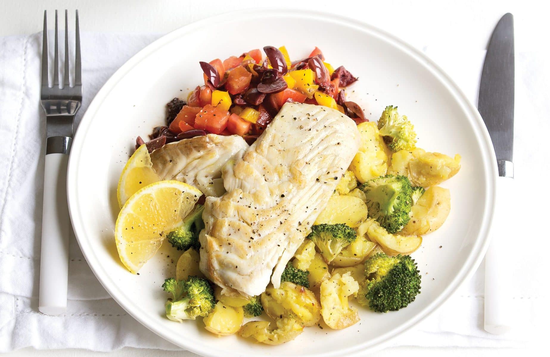 Fish with crushed potatoes and olive salad