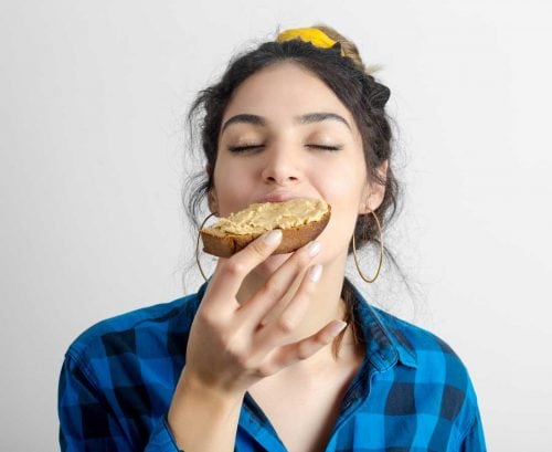 Woman biting into a slice of bread