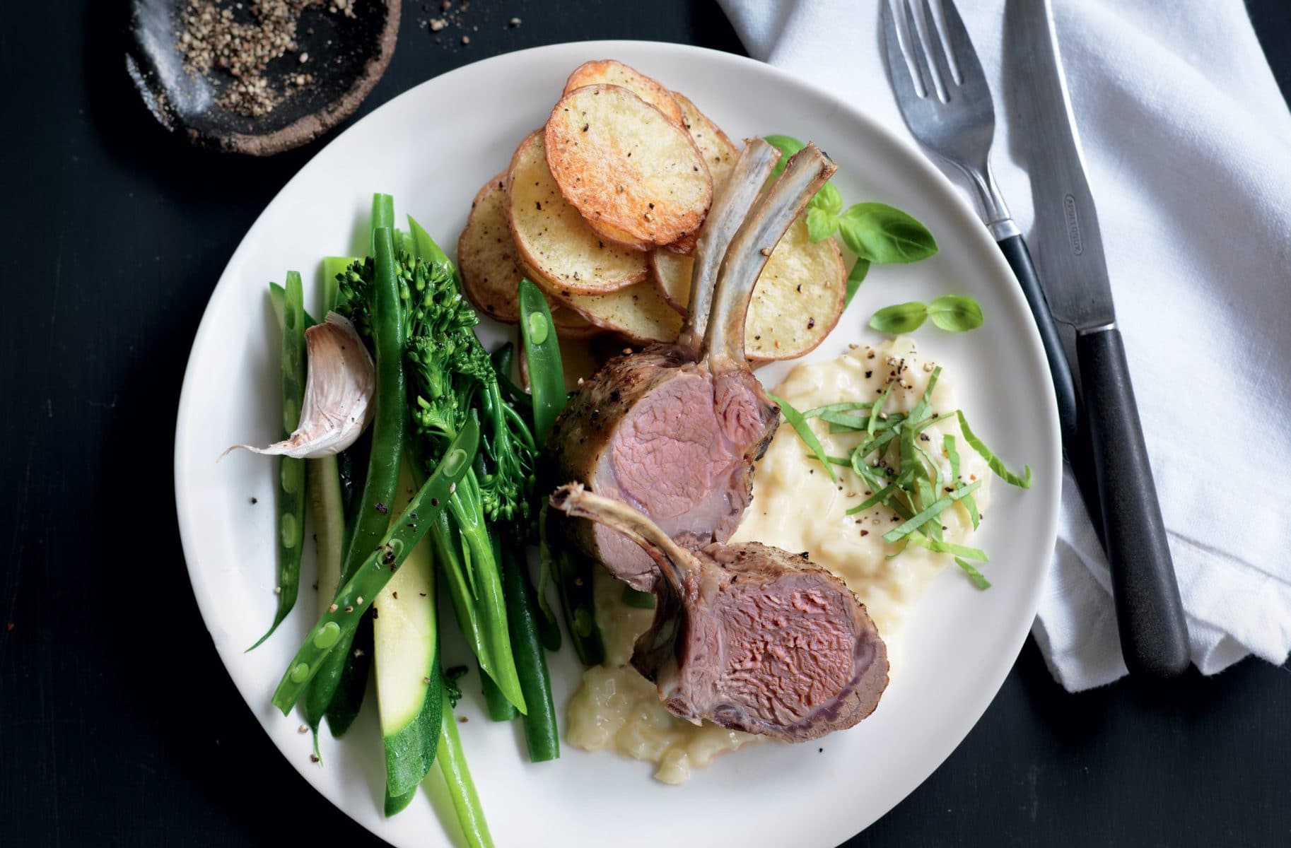 Lamb racks with onion cream sauce and crispy potatoes
