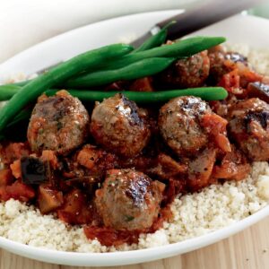 Meatballs in tomato and eggplant sauce with couscous