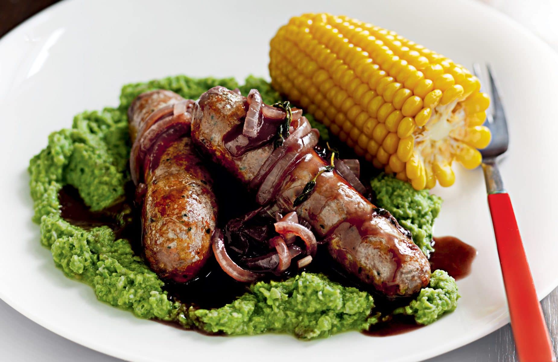 Sausages with pea purée and onion gravy