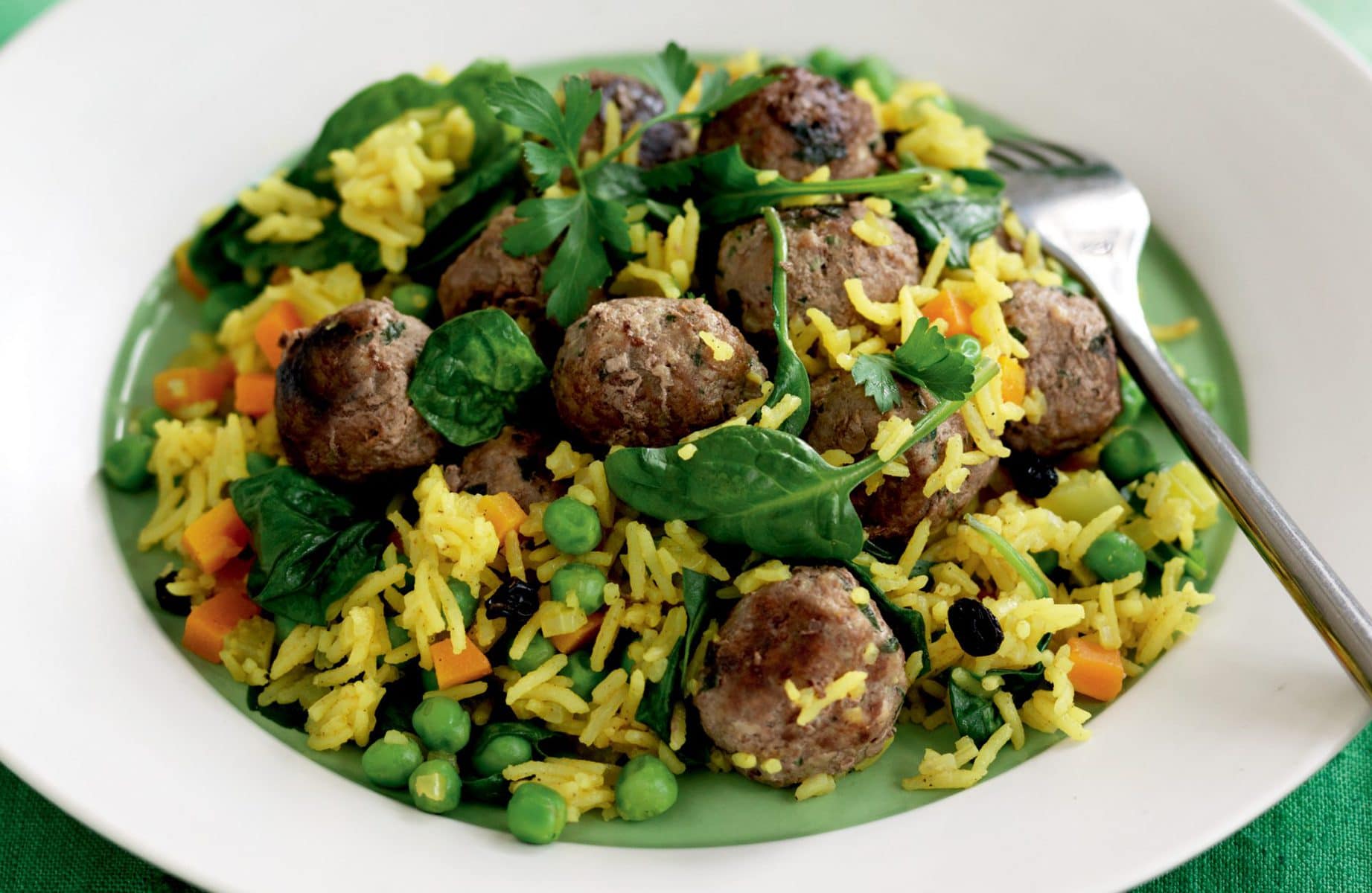 Spiced pilaf with meatballs, currants and baby spinach