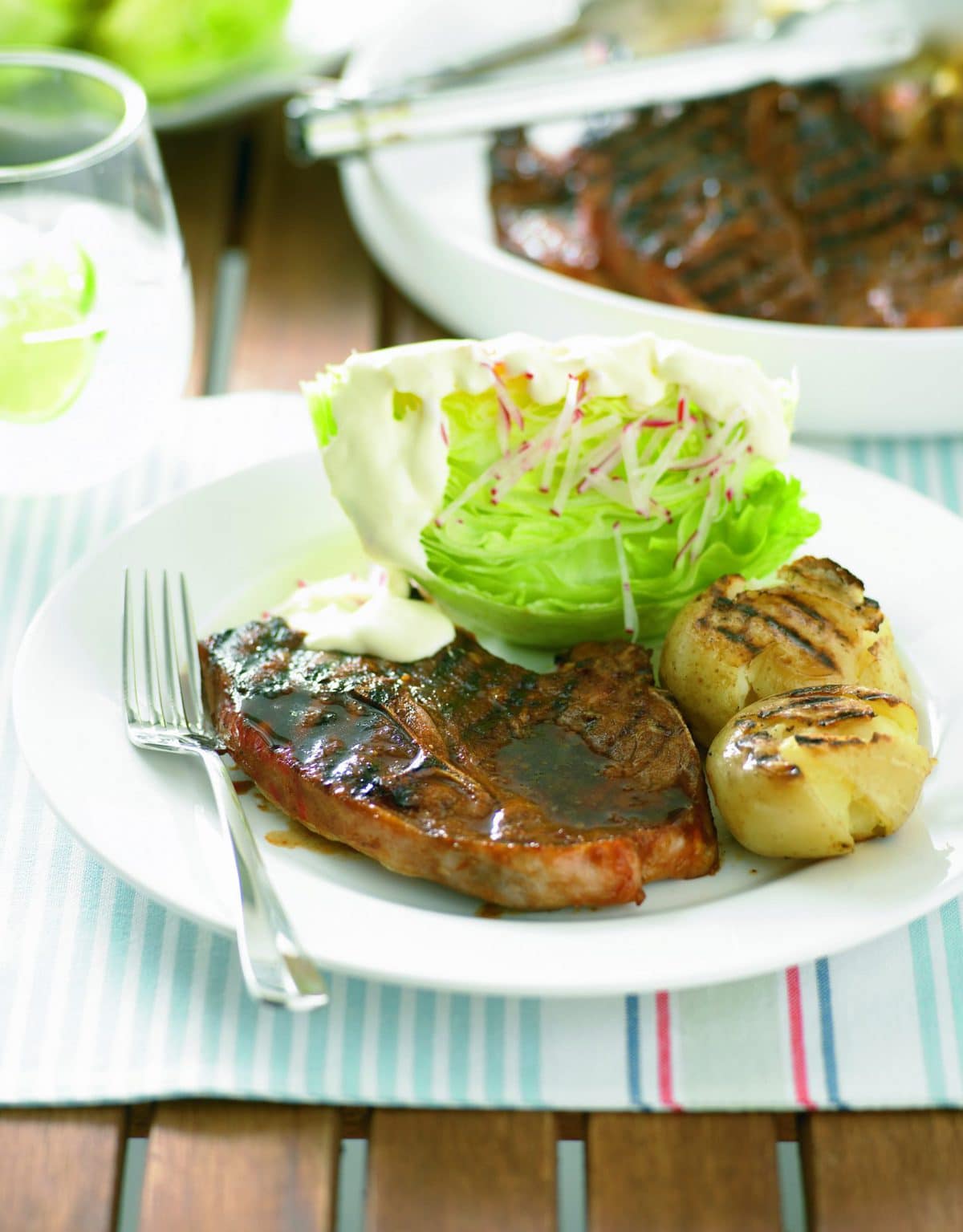 Barbecued lamb chops with potatoes and iceberg lettuce salad