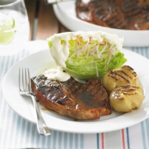 Barbecued lamb chops with potatoes and iceberg lettuce salad