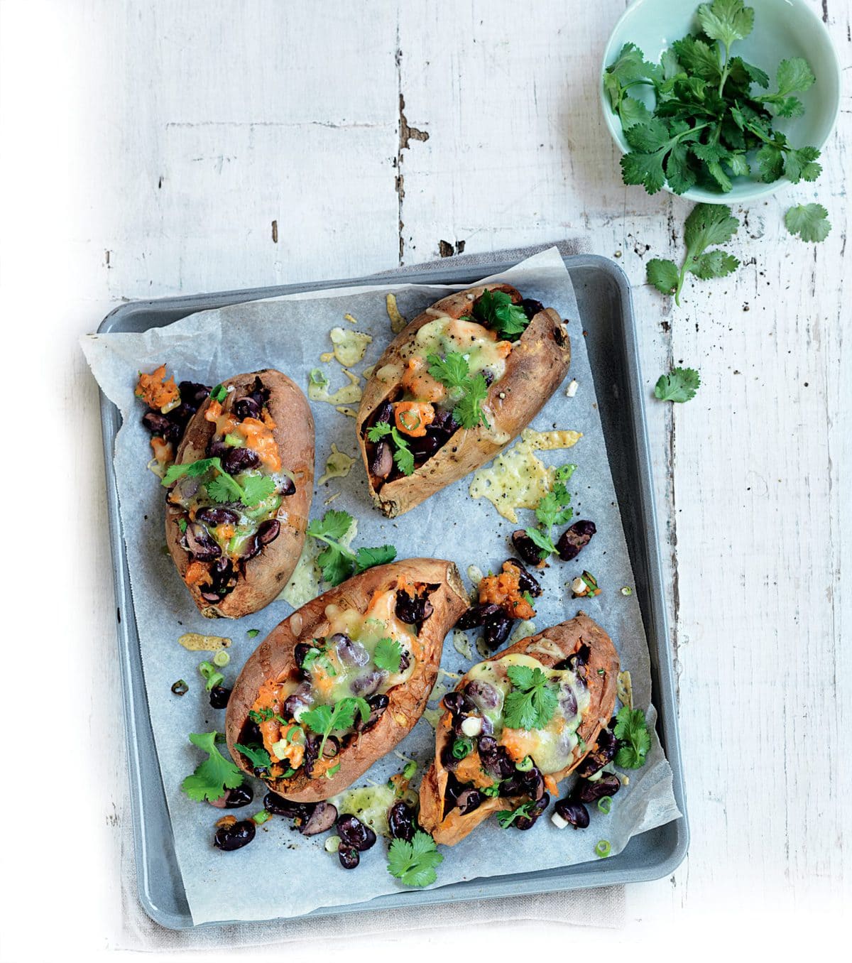 Cheddar, bean and coriander-stuffed sweet potatoes