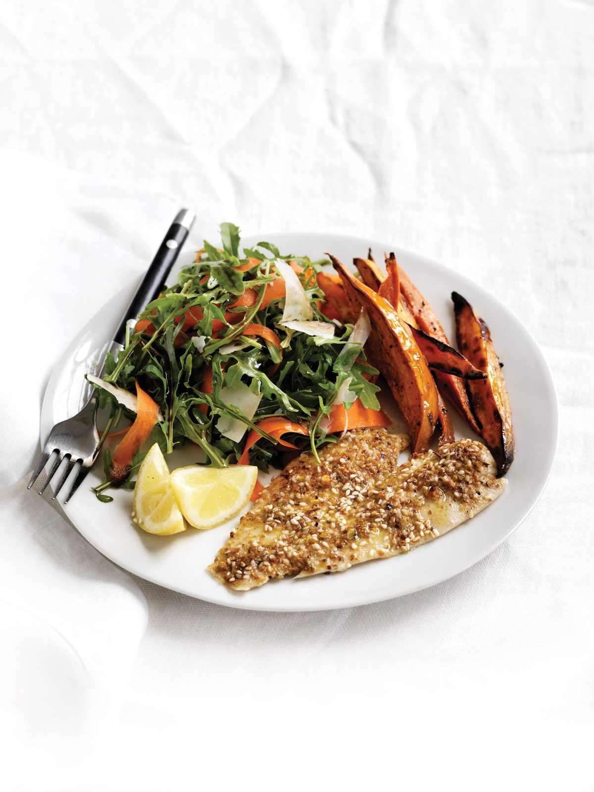 Dukkah-crumbed fish with rocket and parmesan salad and oven-baked chips