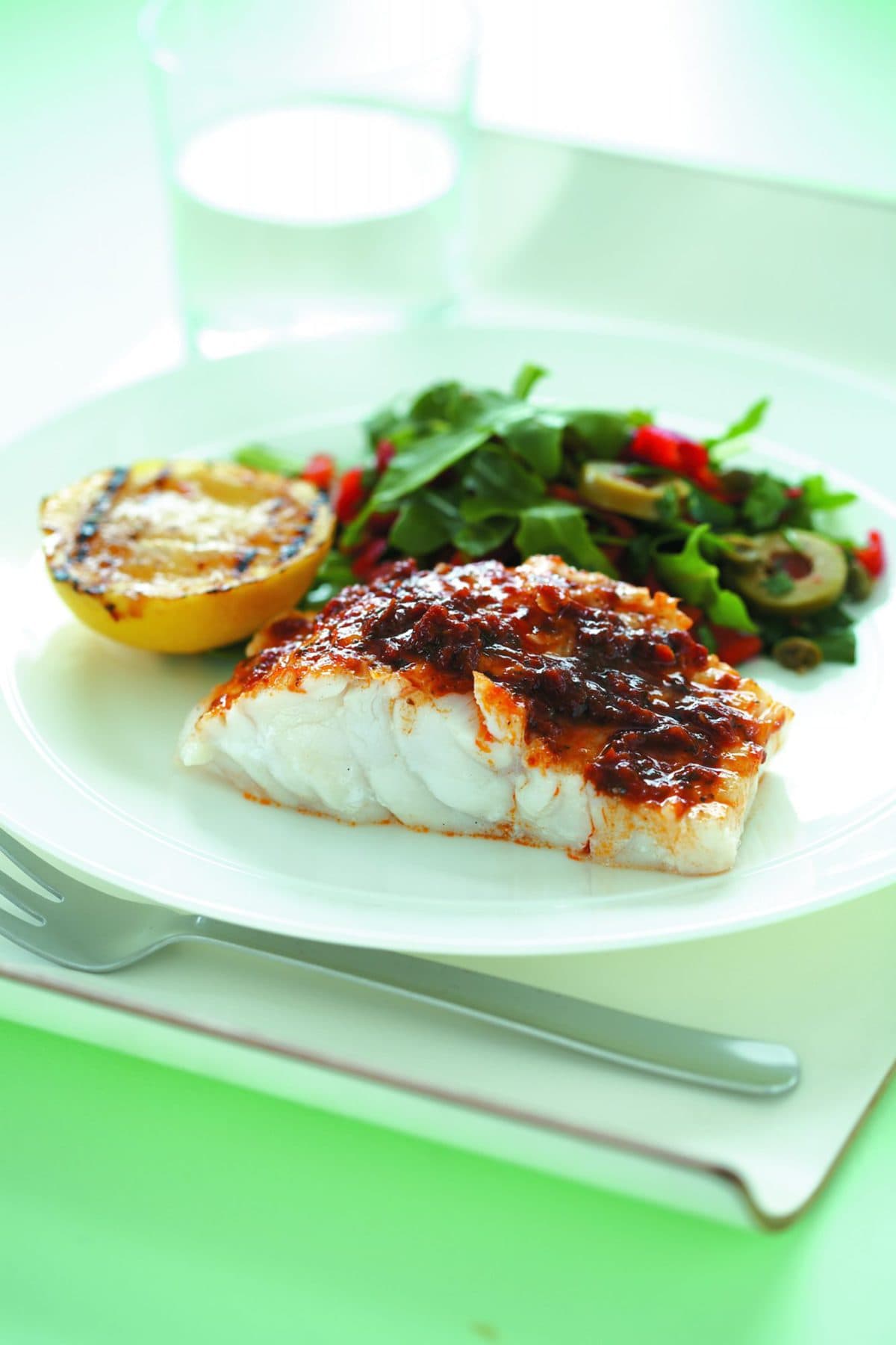Grilled fish and lemon with olive salad