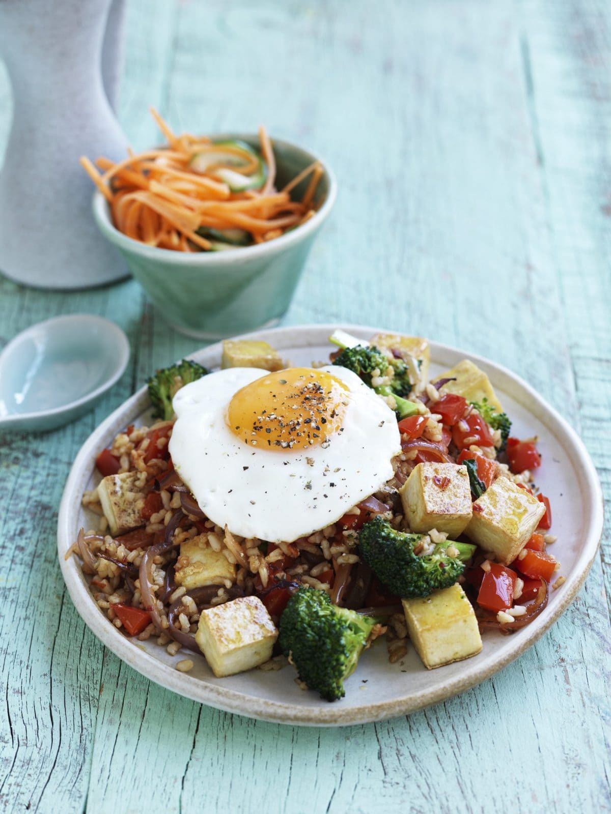 Nasi goreng with fried egg, pickled cucumber and carrot