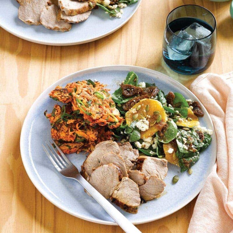 Pork with kumara cakes and fig, orange and silver beet salad