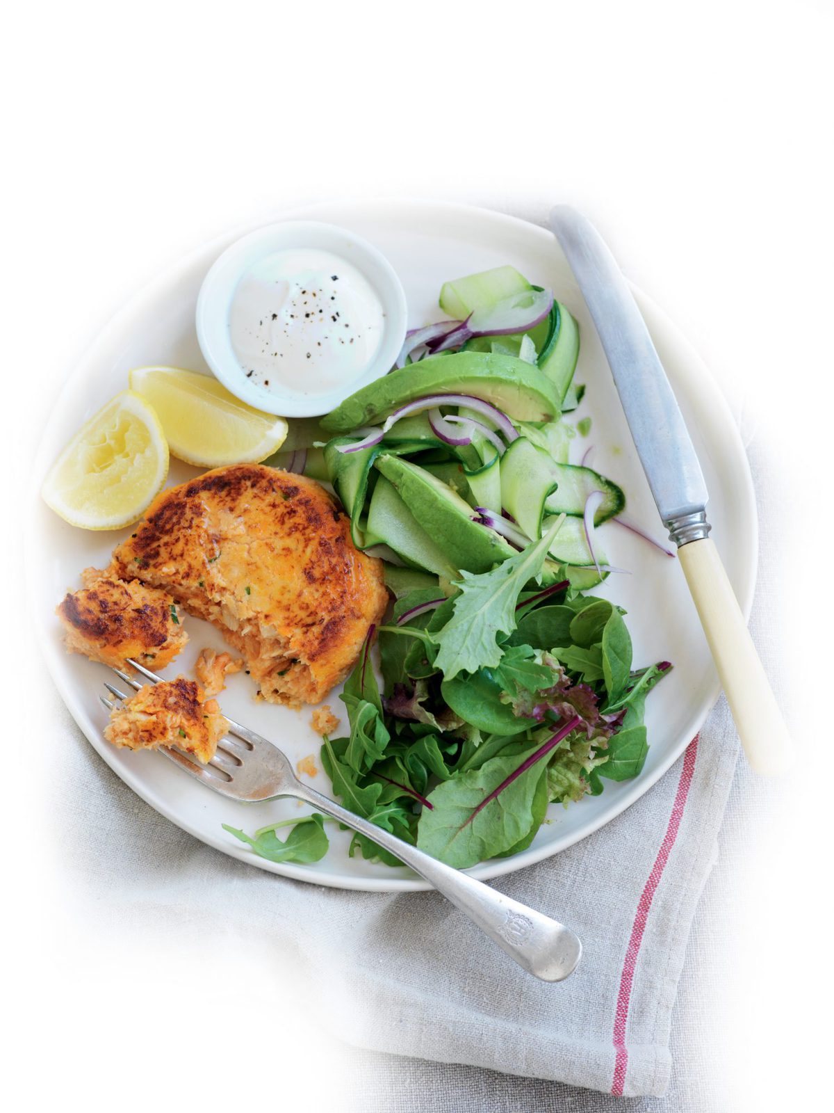 Salmon and kumara cakes with cucumber and avocado salad