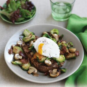 Sautéed sprouts and mushrooms with poached egg