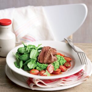 Seared lamb with mint pea mash and roasted tomatoes