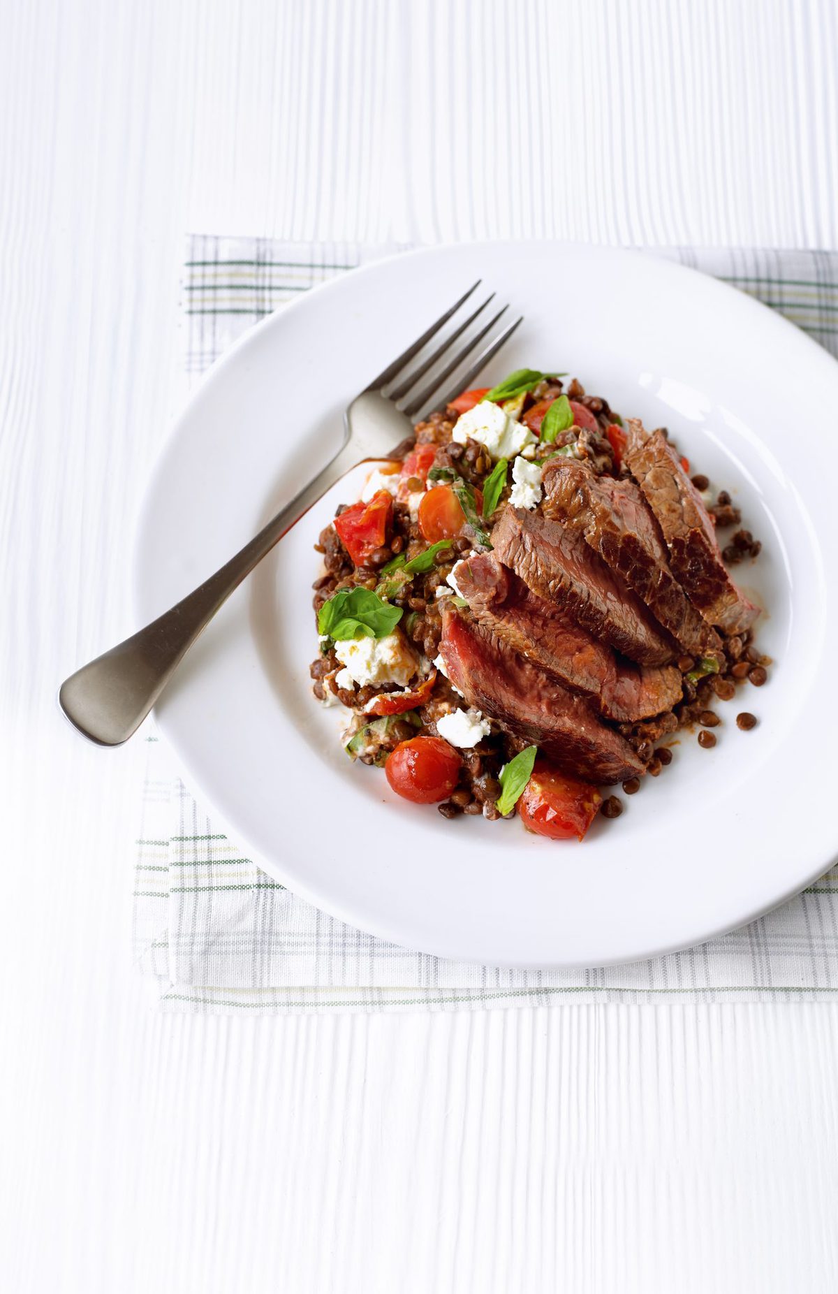 Seared steak with sun-dried tomato lentils