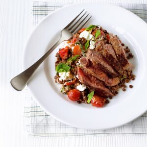 Seared steak with sun-dried tomato lentils