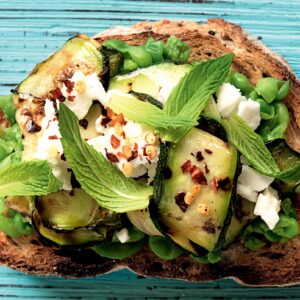 Smashed pea, zucchini, feta and mint toast topper