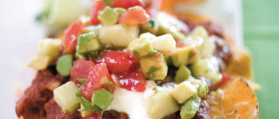 Spicy bean nachos with avocado salsa and salad