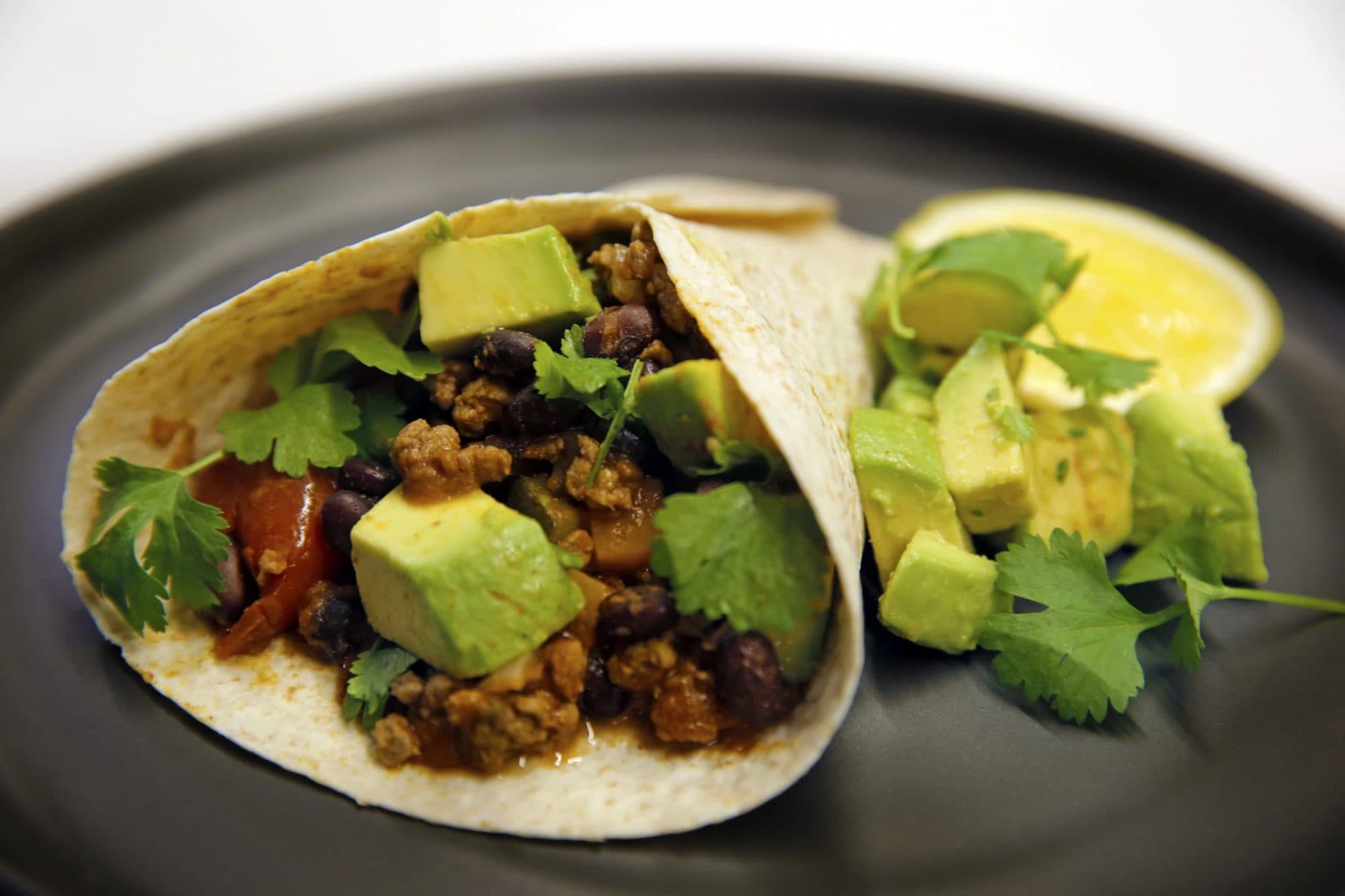 Mexican black beans with spicy avocado and grilled tortilla