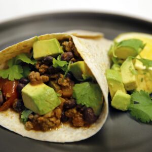 Mexican black beans with spicy avocado and grilled tortilla