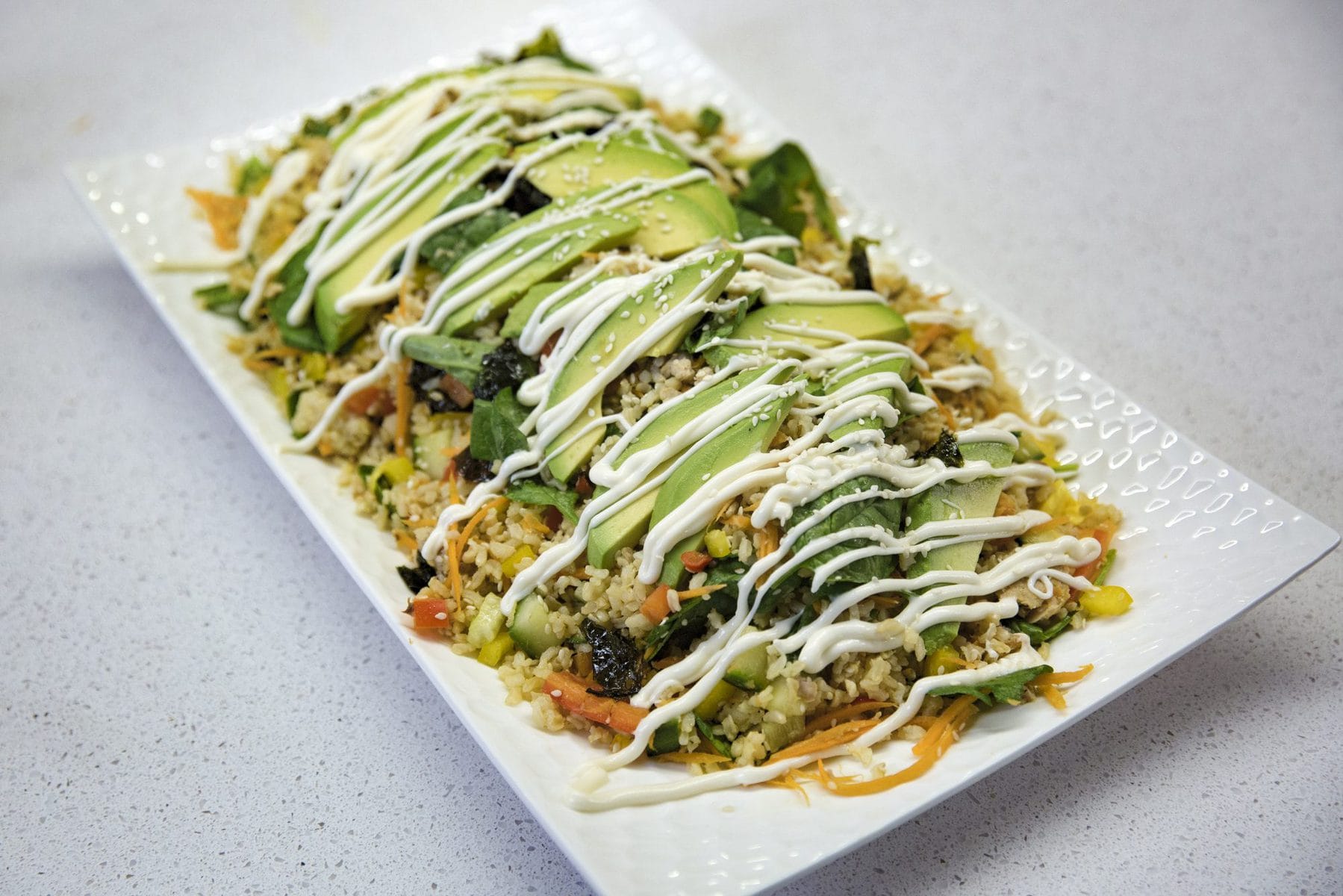 Sushi and avocado salad with garlic mayonnaise