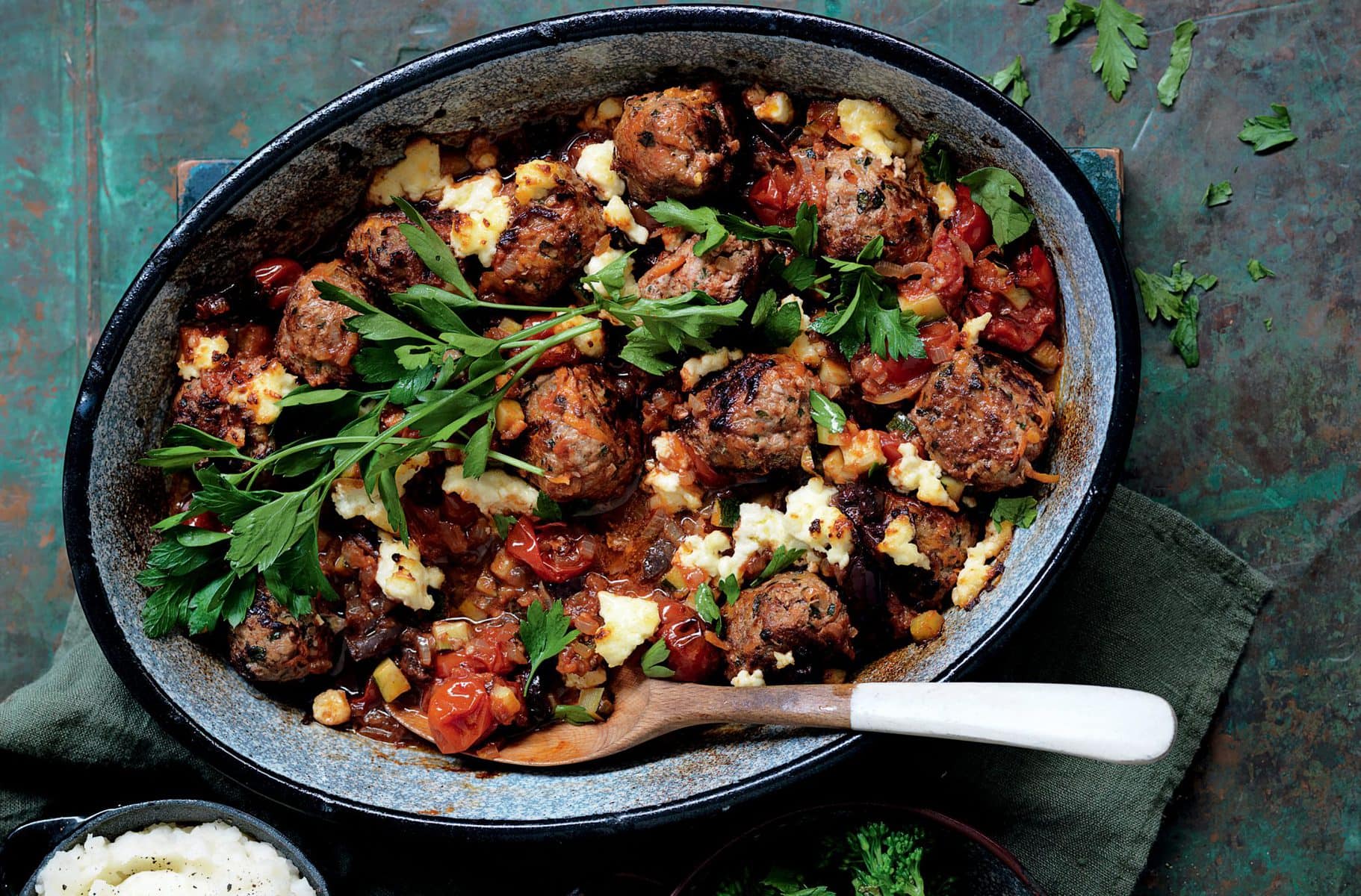 Baked meatballs with tomato, olives and ricotta
