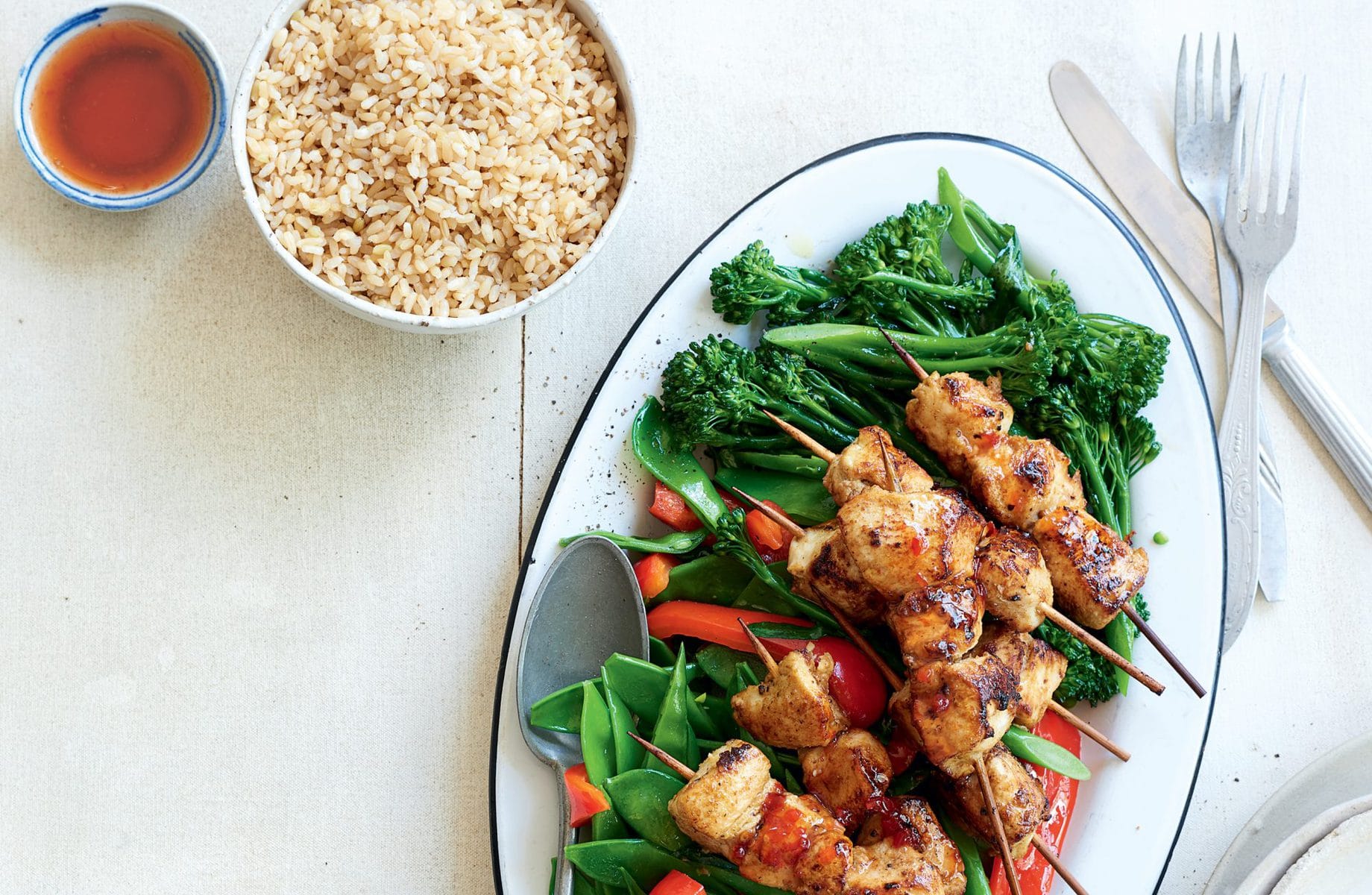 Chicken skewers with stir-fried greens