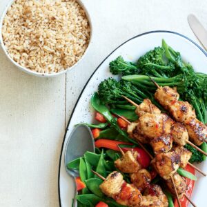Chicken skewers with stir-fried greens