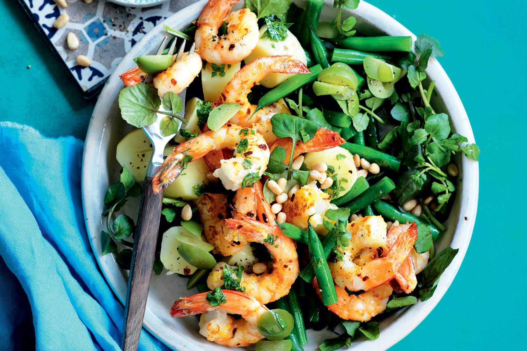 Prawns with green olives, lemon, pine nuts and watercress