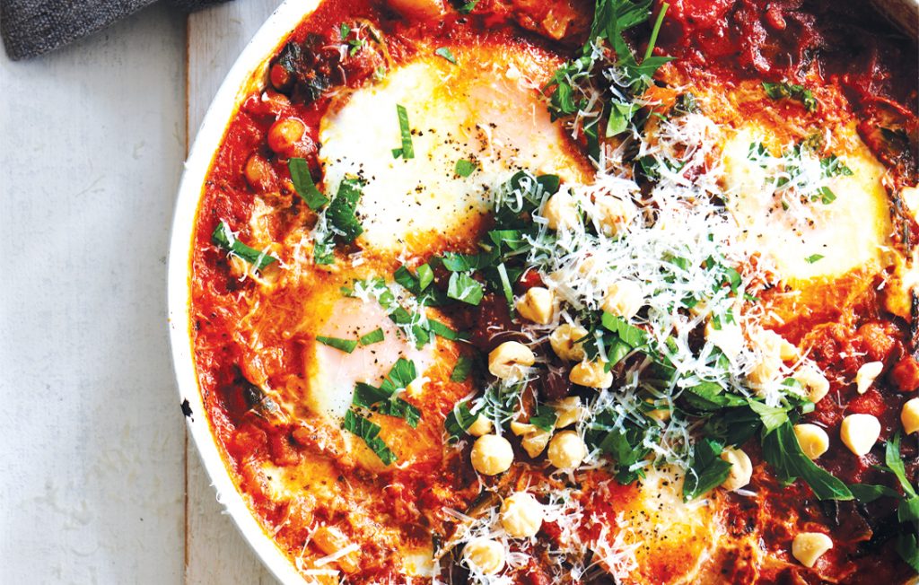 Frying pan baked eggs with harissa and silver beet