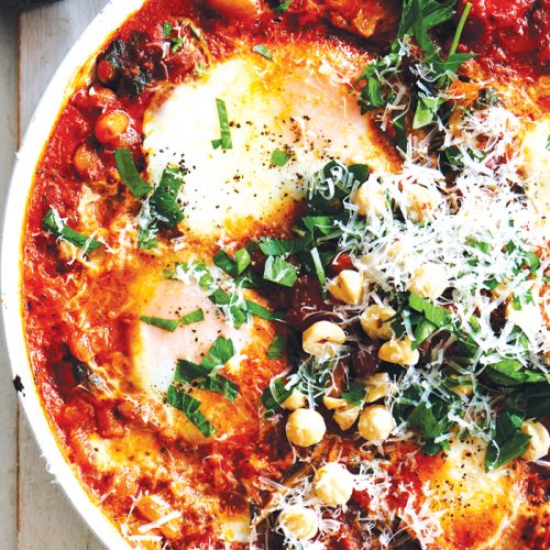 Frying pan baked eggs with harissa and silver beet