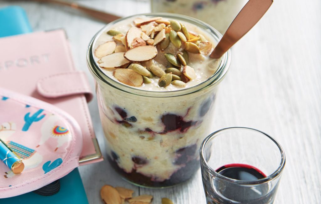 Layered berry oats with a cherry juice shot