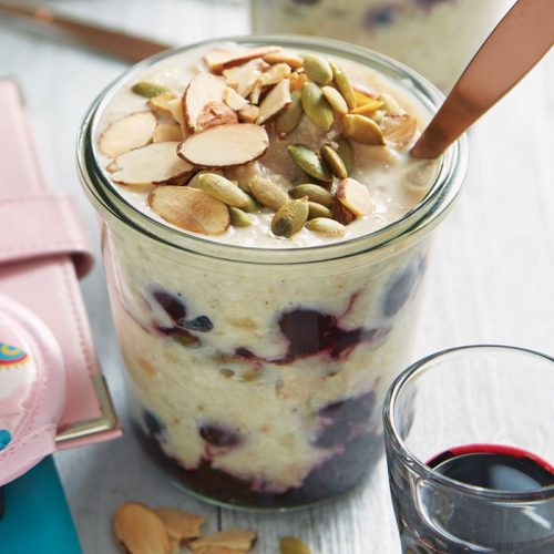 Layered berry oats with a cherry juice shot