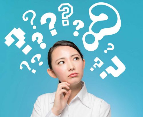 Asian woman with question marks above her head