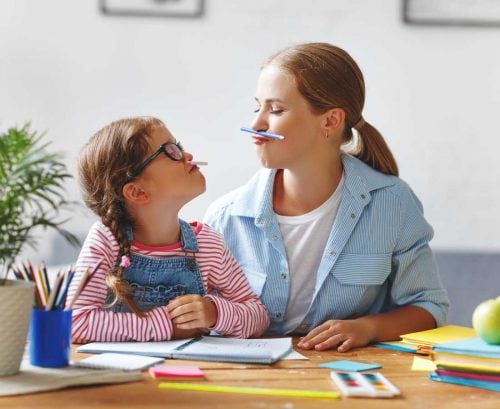 mother and daughter having fun doing home school work