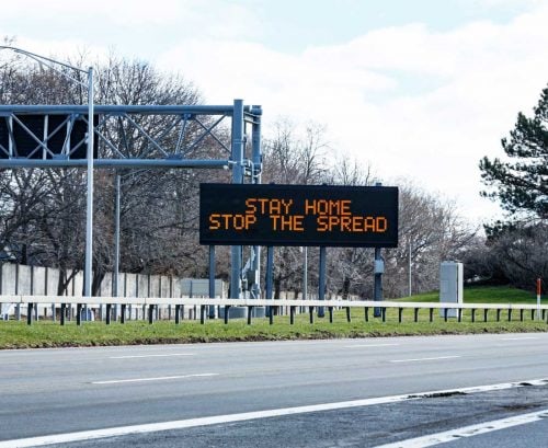 Road sign telling people to stay home to prevent coronavirus spread