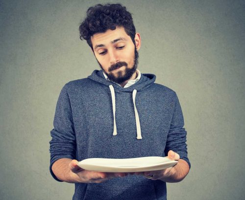 Man holding out an empty plate