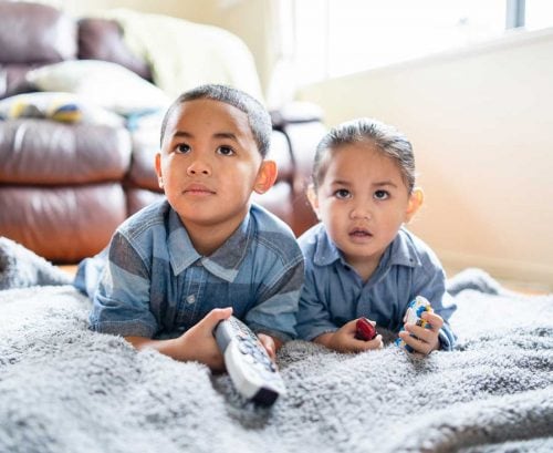 Little boy and girl watching TV