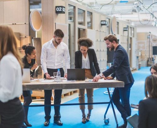 People having a standing meeting at work