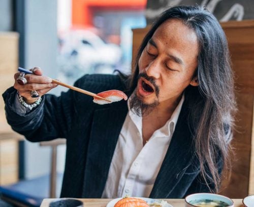 Man eating salmon nigiri